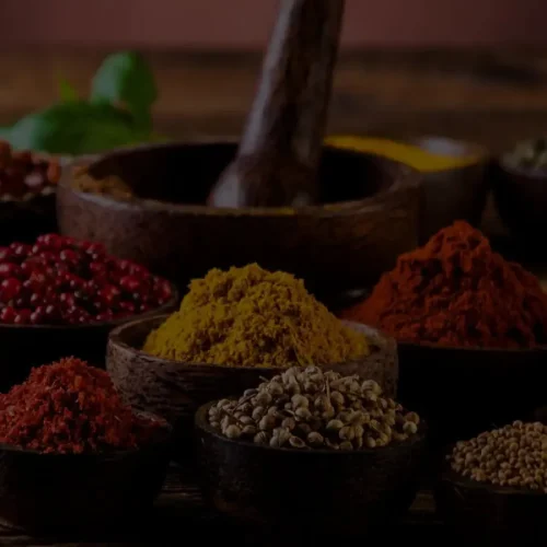 traditional-spice-bowls-arrangement Authentic Indian spices in traditional wooden bowls on rustic table